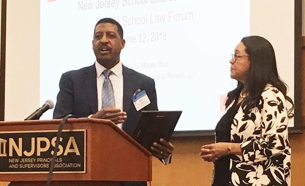 Hope Blackburn (at right), general counsel of Jersey City Public Schools, was honored as the outgoing president of the New Jersey Association of School Attorneys. Presenting a plaque to her is Carl Tanksley, NJSBA director of legal and labor relations services. 